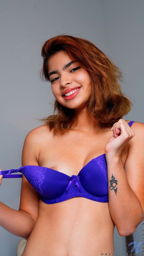 Pretty teen Hazel Heart takes off her bra and panty set before a finger fuck