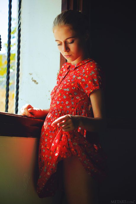 Blonde teen Shayla removes a red dress and socks to pose nude on her bed