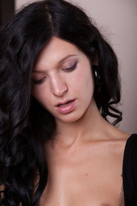 Young beauty Greta A removes a bra and panty set to pose nude