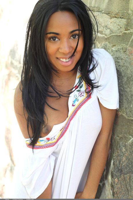 Black teen Tahela models totally naked in a secluded area of the forest