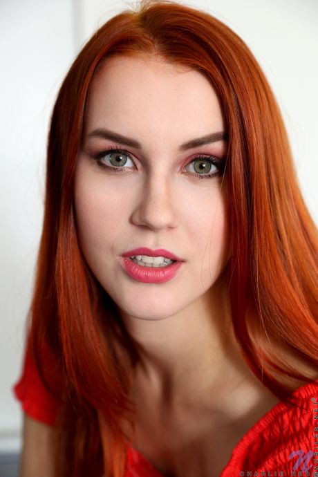 Redheaded teen Charlie Red rocks her tight slit with a dildo in the kitchen