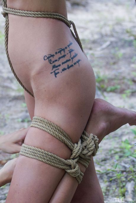 Lean teen Jacinta B is bound to a tree with ropes and a leash