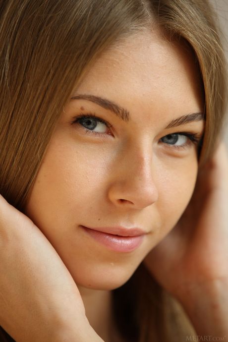 Skinny blonde teen Katherine A demonstrates her big tits and poses naked