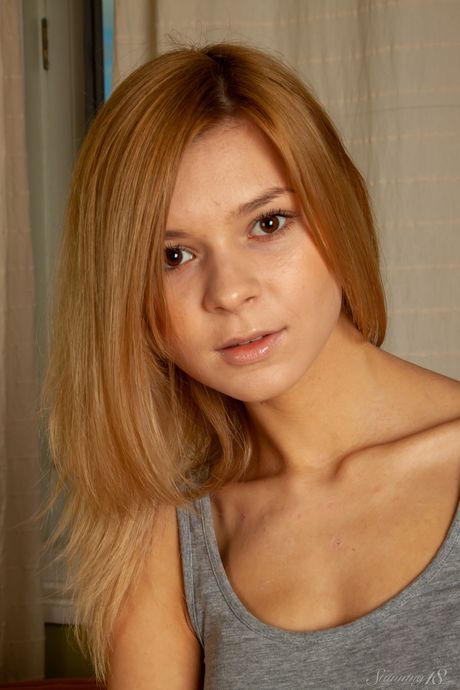 Barely legal girl Paloma B gets naked on a sofa in white socks