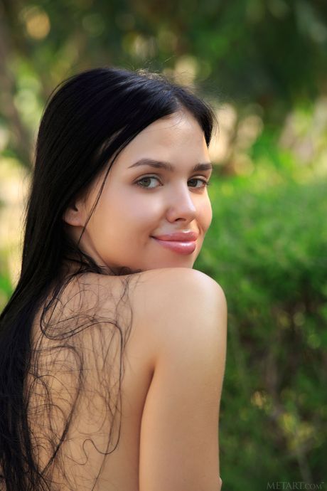 Endearing teen Venice Lei models totally naked on a blanket in a garden