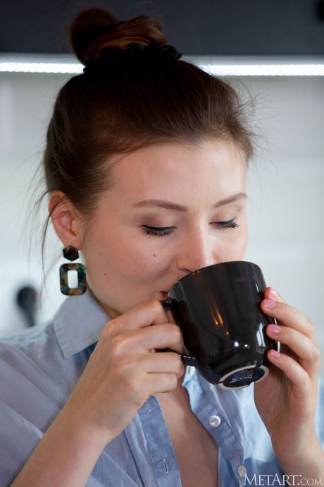 Pretty teen Berenice removes her lingerie and poses nude in the kitchen