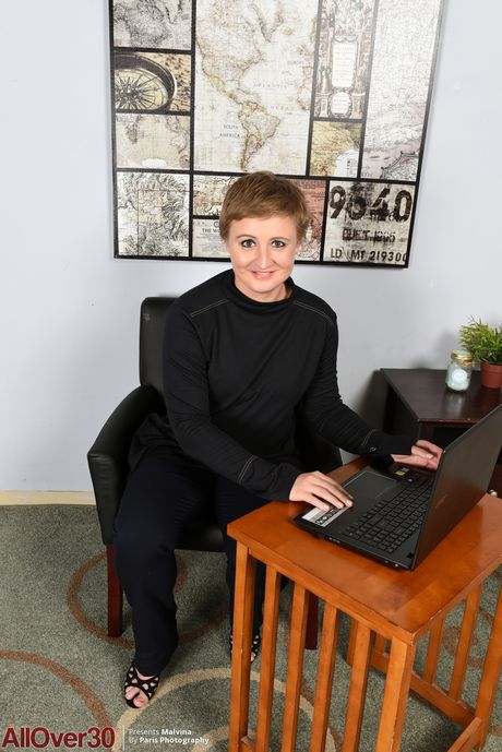 Mature secretary Malvina shows her big ass and spreads her pussyh