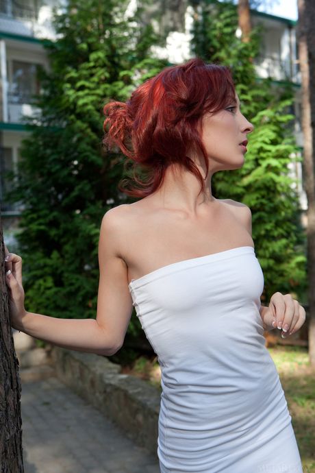 Natural redhead Night A gets totally naked on a patio with conviction