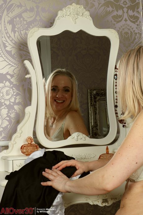 Mature maid Melissa H toys with a dildo in her sexy uniform