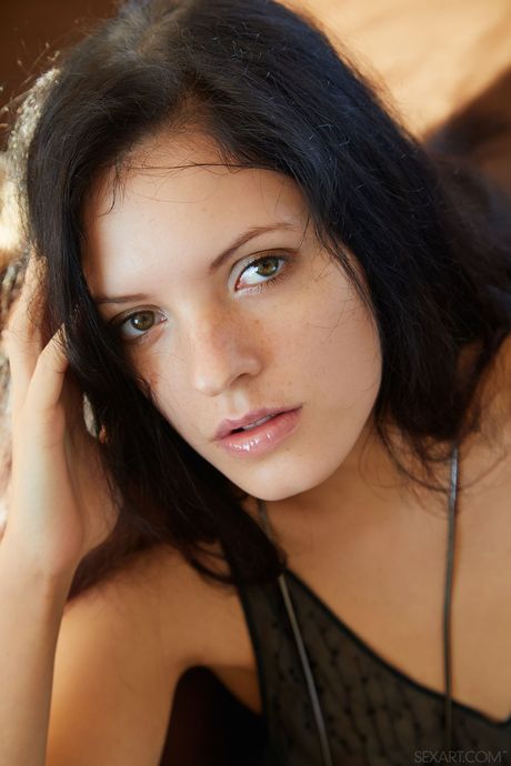 Intriguing teen Anie Darling gets naked in high heels on a sofa in a living room