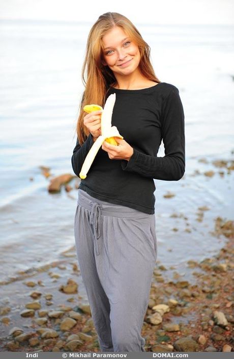 La pelirroja flaca Indi se desnuda en una manta en un campo
