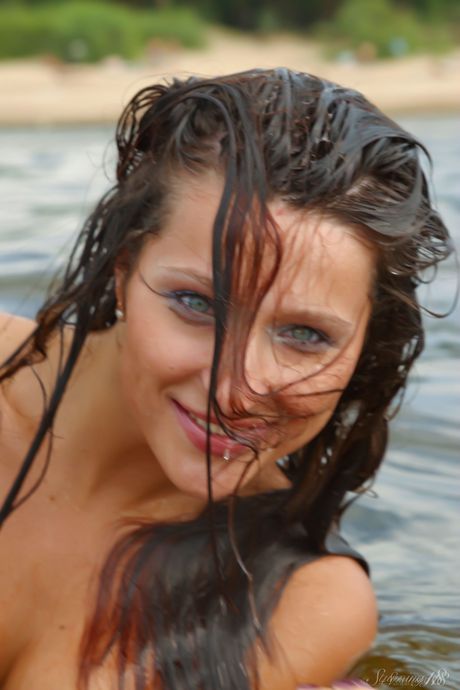 Brunette chick Enio K goes nude on a sandy beach