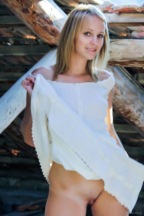 Cute teen Ilona D exposes her small tits and exhibits perfect body in the forest