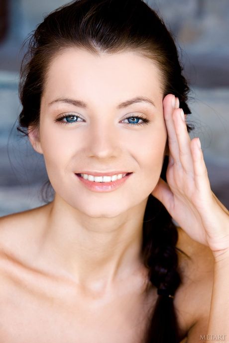 Sexy Russian girl Leila A strips naked in the grass and shows her bald pussy