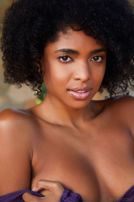 Ebony teen Luna C fingers her pussy after getting naked in heels