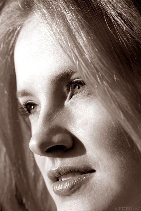 Long legged teen Alice May shows her flexibility and poses naked on a beach