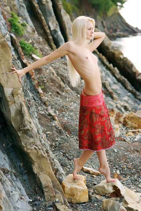 Skinny Russian girl Faina poses naked in the forest & shows her big tits