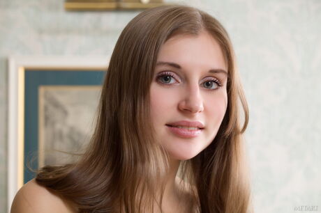 Lean teen Viva B demonstrates her big tits and bald pussy