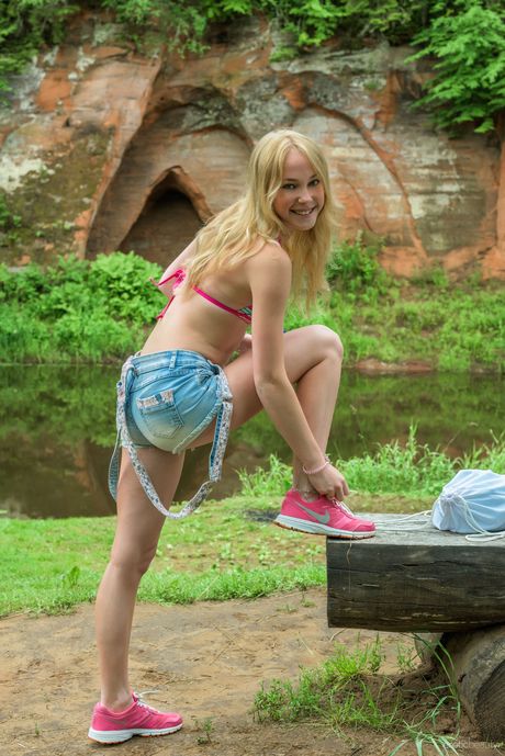 Erotic Beauty: Blonde teen Runa gets naked in high heels on a patio in a sexy manner