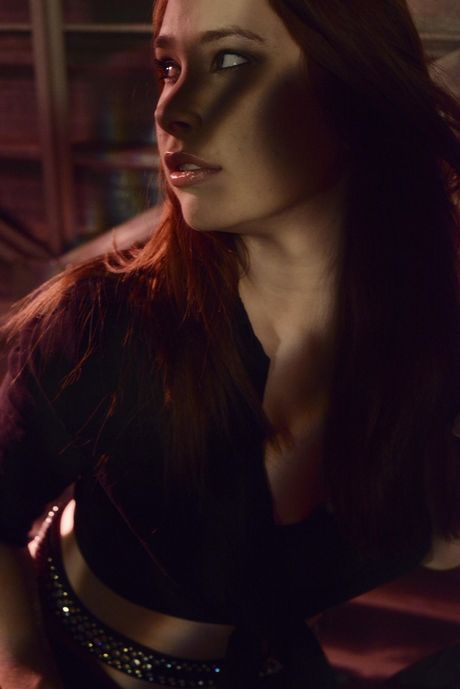 Sexy redhead Melody Jordan fingers her pussy in black stockings & boots