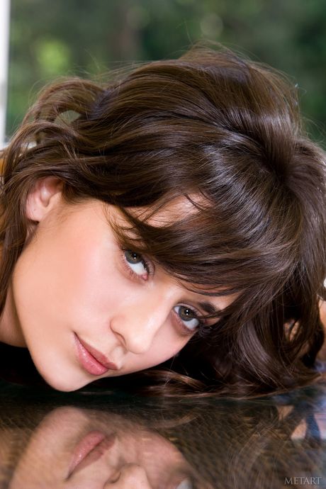 Sexy Russian babe Irina B gets naked on a patio chair in the sun