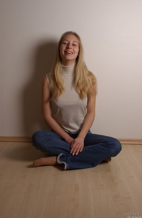 Slender teen Lucy S shows her small tits and poses naked in a solo