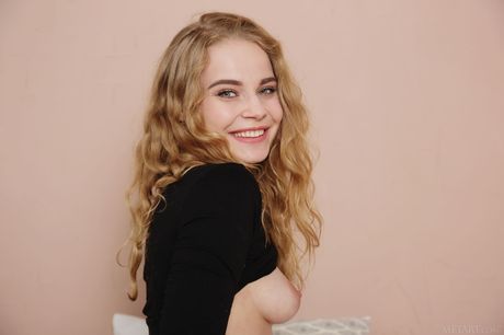 Sexy blonde teen Ellie removes her clothes to pose nude confidently