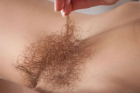 Skinny redhead Dennie shows her hairy pussy and small tits