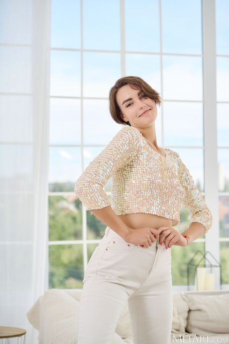 Alluring teen Erika Luchini removes her clothes and poses nude