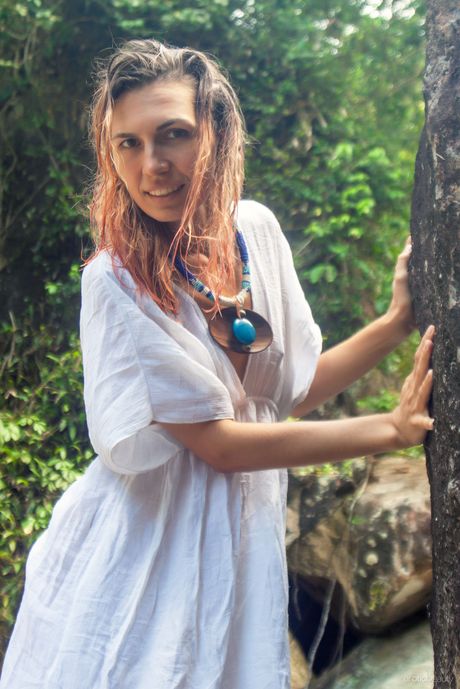 Nice teen Noelia models totally naked on a rock in a shady setting