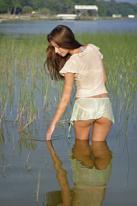 Angelic teen Amelia Lake strips down on a dock in a pond