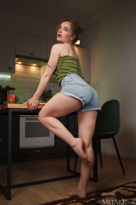 Sexy redheaded teen Felice gets naked in the kitchen while cooking