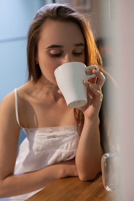 Bashful teen Messiah gets naked in a kitchen while wearing socks