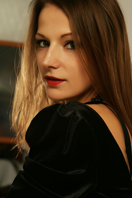 Young girl Kalova removes a black bra and panty set to get totally naked