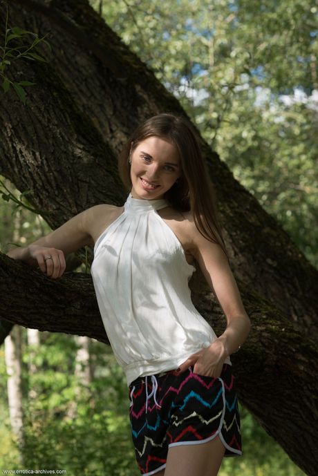 Slender teen Vialika takes it all off on a tree stump without embarrassment