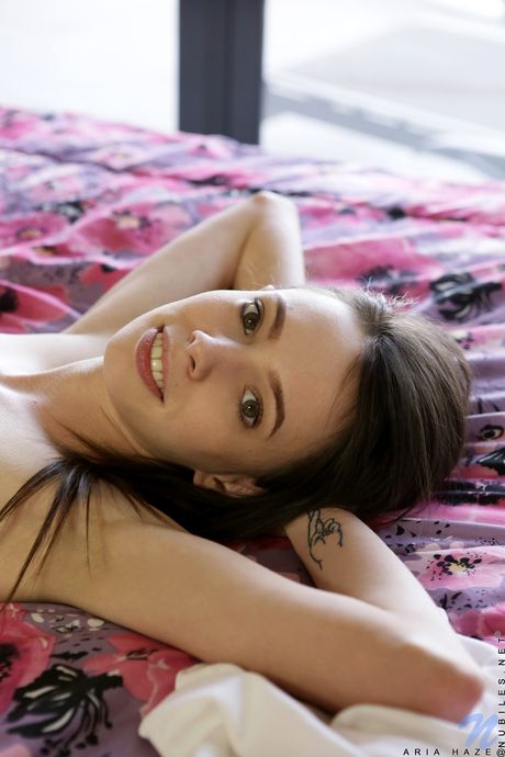 Petite teen Aria Haze shows her small boobs and shaved pussy in a solo