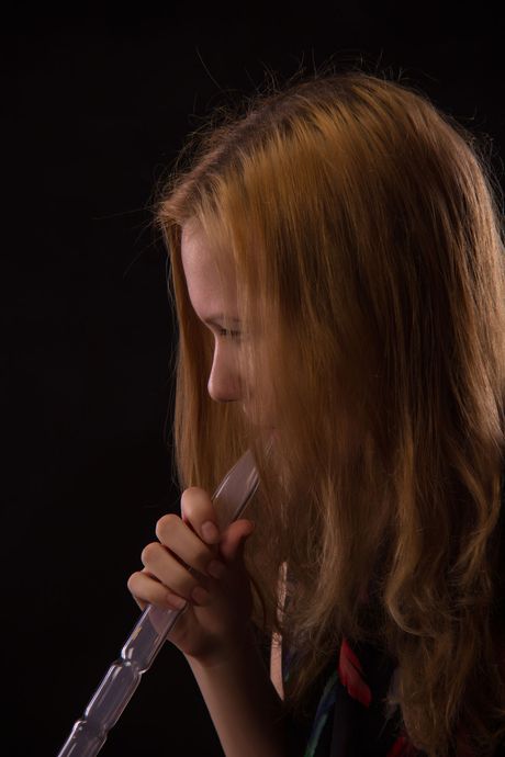 Redheaded teen Anna B removes her lingerie and poses nude in stockings