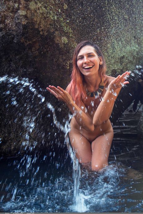 Young brunette Noelia goes naked on a rocky beach