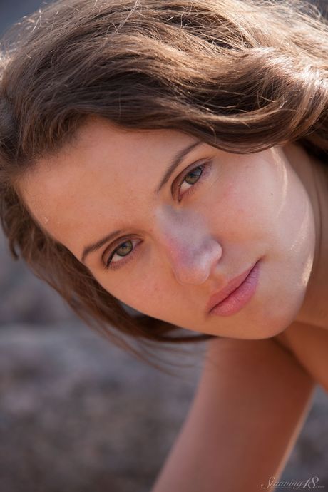 Innocent teen Lucy G bares it all on a rocky outcropping in the nude