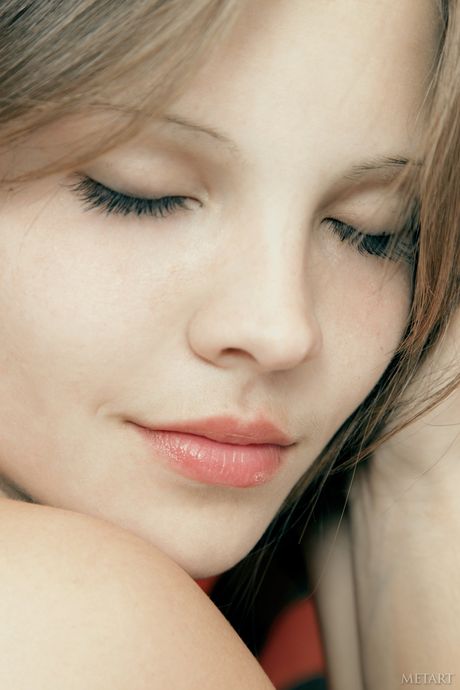 Beautiful teen Ariana A removes her lingerie and stockings to pose nude