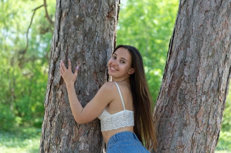 Brunette teen Alay models totally naked against a tree with conviction