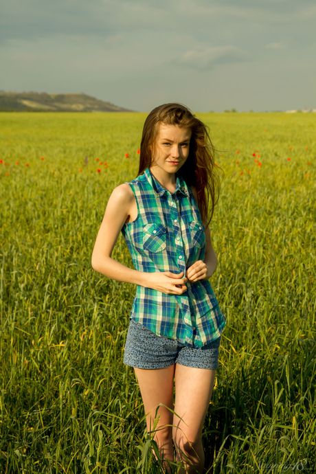 Young blonde Emily Bloom bares herself in a field of wildflowers