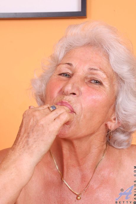 Mature granny Norma shows her big tits and masturbates in stockings