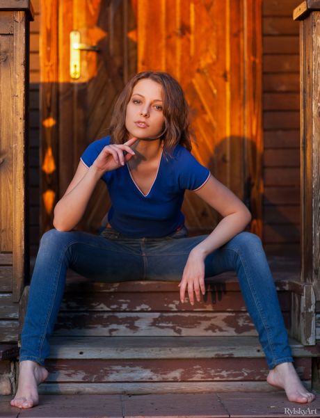 Young blonde Nikia gets nude on a balcony overlooking the sea