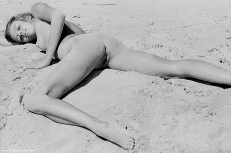 Skinny Russian beautiful Olga strips and poses nude in the sandy terrain