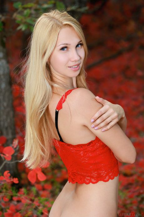 Skinny blonde teen Kendell shows her tiny tits and poses nude in nature