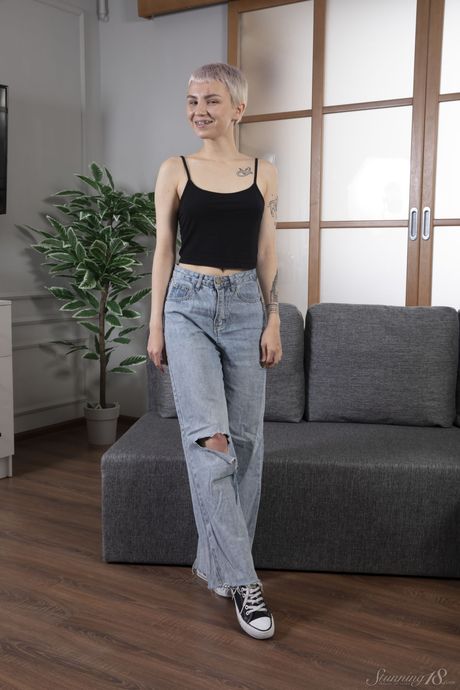 Bramble Bee exhibits her tiny tits and shaved pussy in a solo