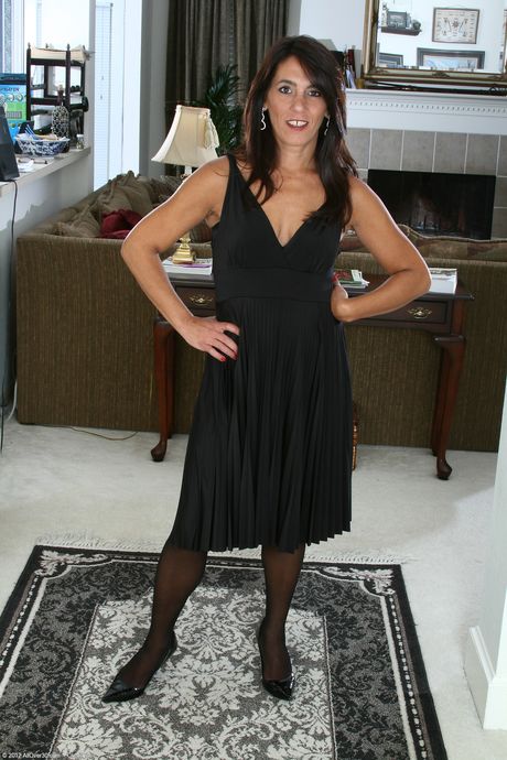 Mature lady Stacey shows her saggy tits and bushy crotch in stockings