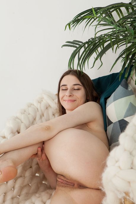 Busty teen Clary bares herself on a dining table during solo action