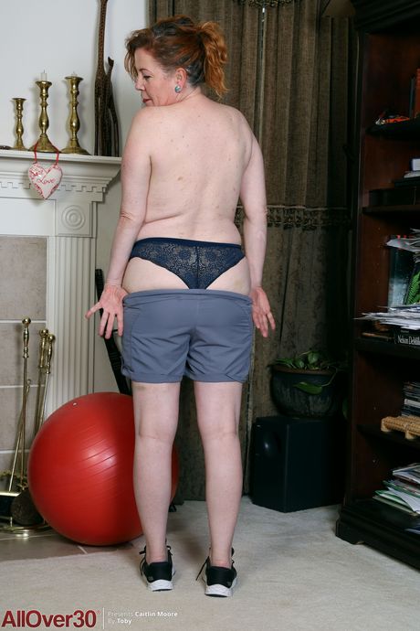 Redheaded BBW Caitlin Moore shows her big tits and spreads her twat